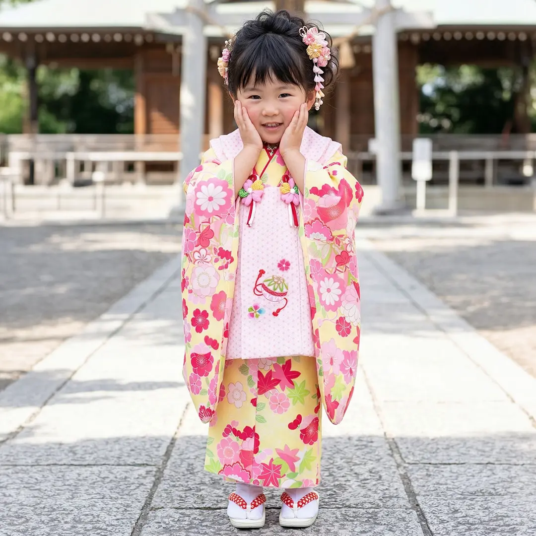 クリームイエローに花尽くしと鞠、ピンク色の麻の葉模様の被布コートセット／七五三・三歳女の子／着用イメージ